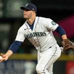 Seattle Mariners first basemamn Ty France tosses to first base after fielding a groudn ball during a baseball game against the Minnesota Twins, Tuesday, June 14, 2022, in Seattle. The Mariners won 5-0. (AP Photo/Stephen Brashear)