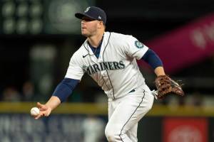Seattle Mariners first basemamn Ty France tosses to first base after fielding a groudn ball during a baseball game against the Minnesota Twins, Tuesday, June 14, 2022, in Seattle. The Mariners won 5-0. (AP Photo/Stephen Brashear)