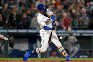 Seattle Mariners' Julio Rodriguez hits an RBI-double to score Dylan Moore during the sixth inning of a baseball game against the Oakland Athletics, Sunday, July 3, 2022, in Seattle. (AP Photo/Ted S. Warren)