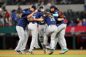 The Seattle Mariners dance in a circle after the final out of the baseball game against the Texas Rangers in Arlington, Texas, Sunday, July 17, 2022. The Mariners won 6-2. (AP Photo/LM Otero)