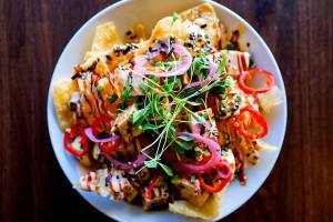 Bar Dojo's colorful vegan nachos boast marinated organic tofu poke, Asian slaw, cilantro and vegenaise sriracha lime aioli on top of crispy wonton shells. (Photo courtesy of Bar Dojo)