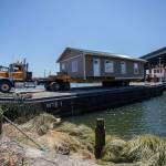 Nickel Bros successfully move Bill Liles home onto a barge in Ebey Slough to make its way out to Hat Island on Thursday, July 21, 2022 in Marysville, Washington. (Olivia Vanni / The Herald)