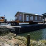Nickel Bros successfully move Bill Liles’ home onto a barge to make its way out to Hat Island on Thursday, July 21, 2022 in Marysville, Washington. (Olivia Vanni / The Herald)