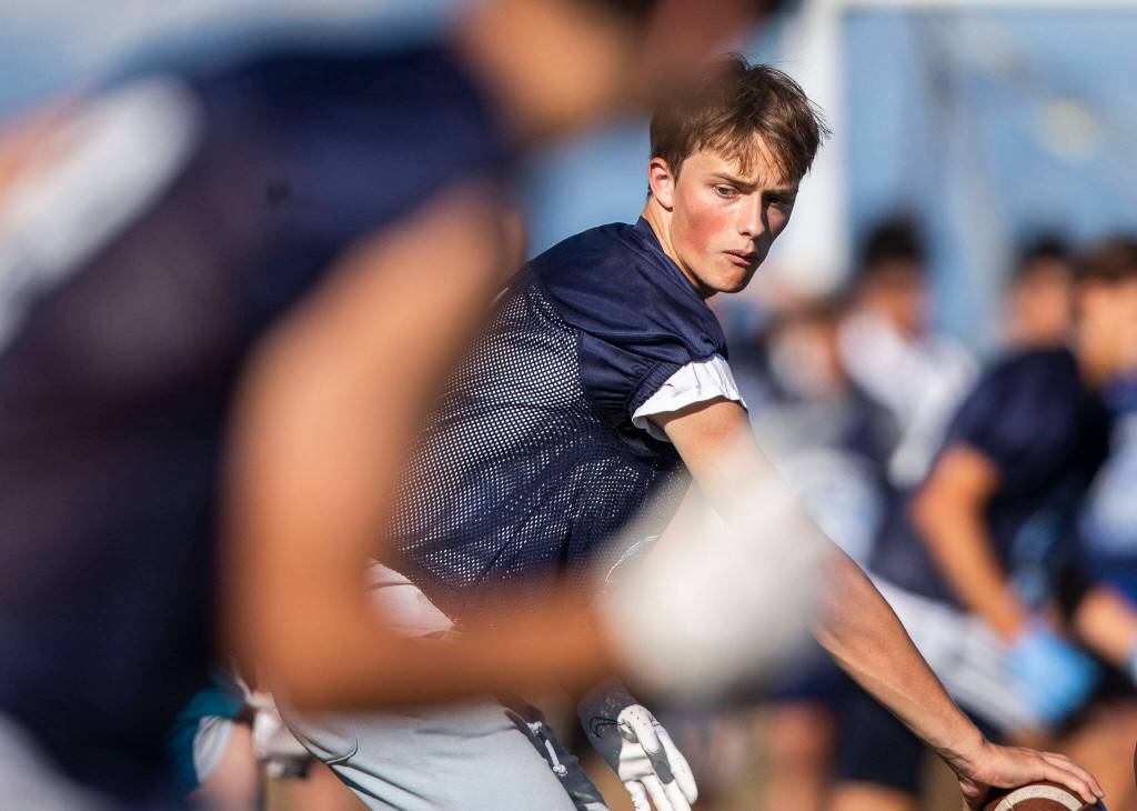 A Meadowdale quarterback calls out a play during a 7on7 game at Glacier Peak High School on Wednesday, July 20, 2022 in Snohomish, Washington. (Olivia Vanni / The Herald)