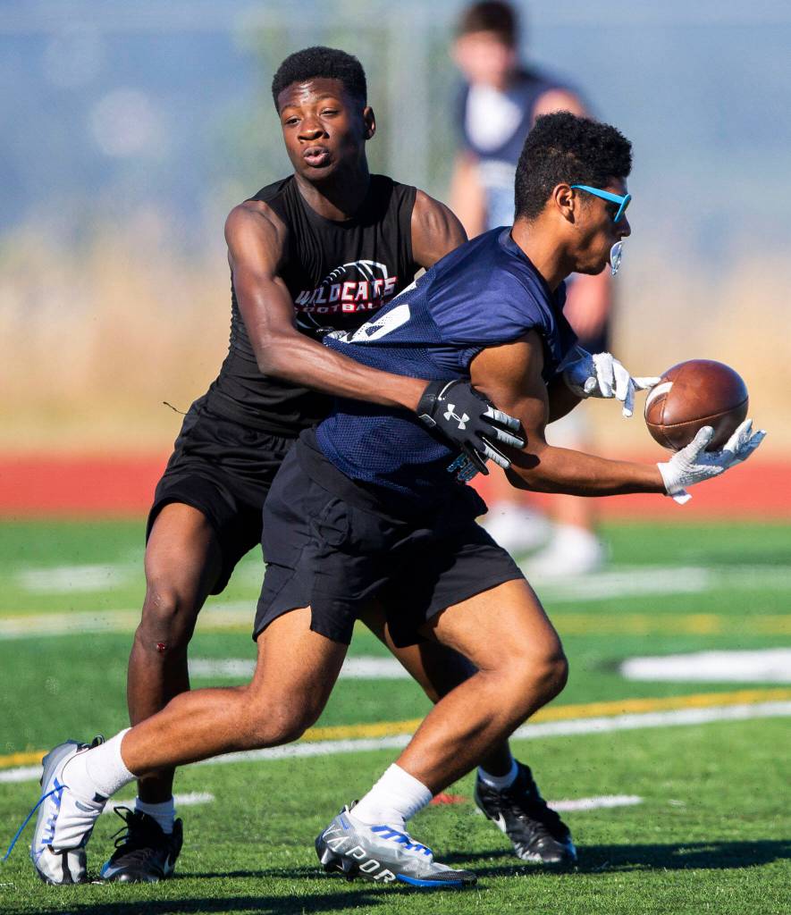 An Archbishop Murphy player tackles a Meadowdale player during a 7on7 game at Glacier Peak High School on Wednesday, July 20, 2022 in Snohomish, Washington. (Olivia Vanni / The Herald)