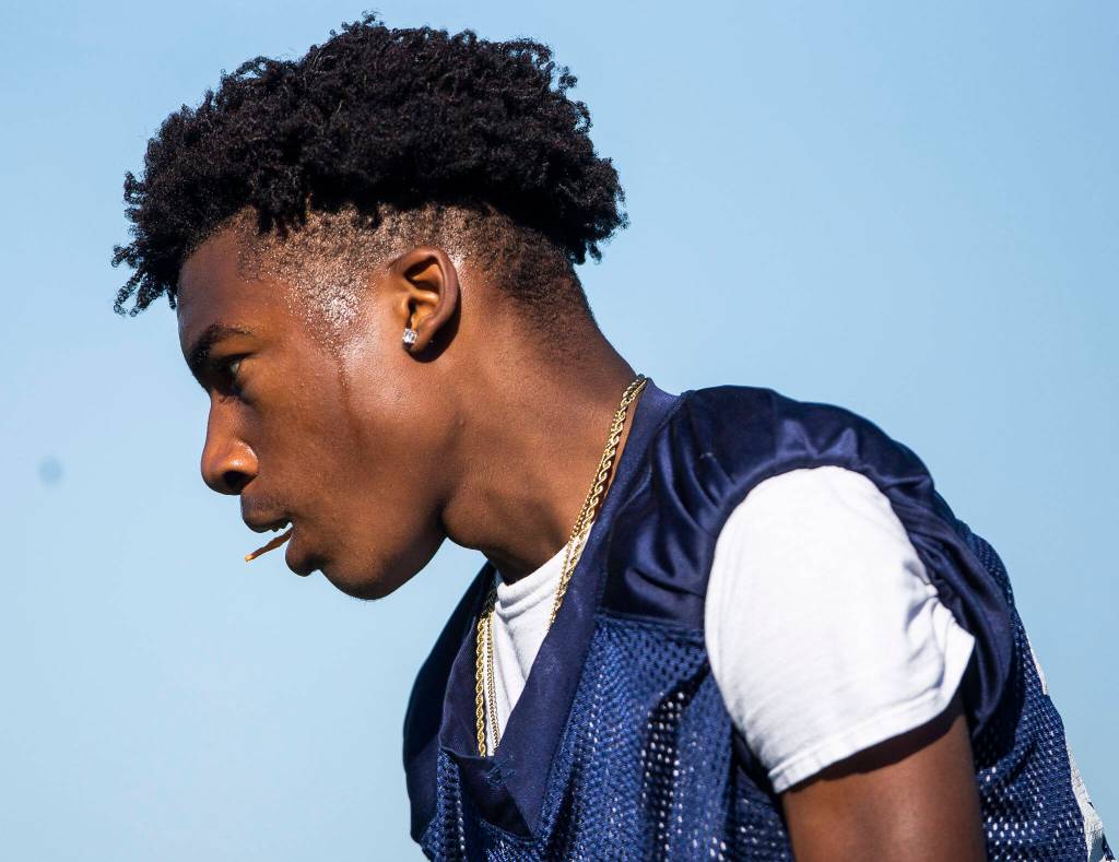 Sweat drips down the face of Meadowdales Jordan Gray as he lines up to run a play during 7on7 game against on Wednesday, July 20, 2022 in Snohomish, Washington. (Olivia Vanni / The Herald)