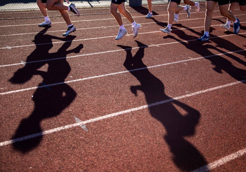 Glacier Peak players warm up on the track before their 7on7 game on Wednesday, July 20, 2022 in Snohomish, Washington. (Olivia Vanni / The Herald)