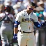 Seattle Mariners Ty France holds his helmet after striking out swinging with a man on base to end the seventh inning of a game against the Houston Astros on Sunday in Seattle. (AP Photo/Ted S. Warren)