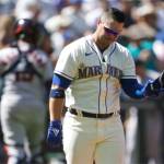 Seattle Mariners' Ty France holds his helmet after striking out swinging with a man on base to end the seventh inning of a baseball game against the Houston Astros, Sunday, July 24, 2022, in Seattle. (AP Photo/Ted S. Warren)