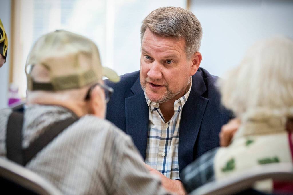 Sam Low, a candidate for state representative, talks with seniors Wednesday morning in Lake Stevens, Washington on July 20, 2022. (Kevin Clark / The Herald)