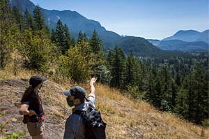 Rachel Chesley, left, and Sam Chesley, right, point out some of the forested area that is purposed to be cut for timber on Wednesday, July 29, 2020 in Gold Bar, Wa. (Olivia Vanni / The Herald)