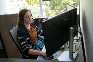 A Volunteers of America Western Washington crisis counselor talks with somebody on the phone Thursday, July 28, 2022, in at the VOA Behavioral Health Crisis Call Center in Everett, Washington. (Ryan Berry / The Herald)