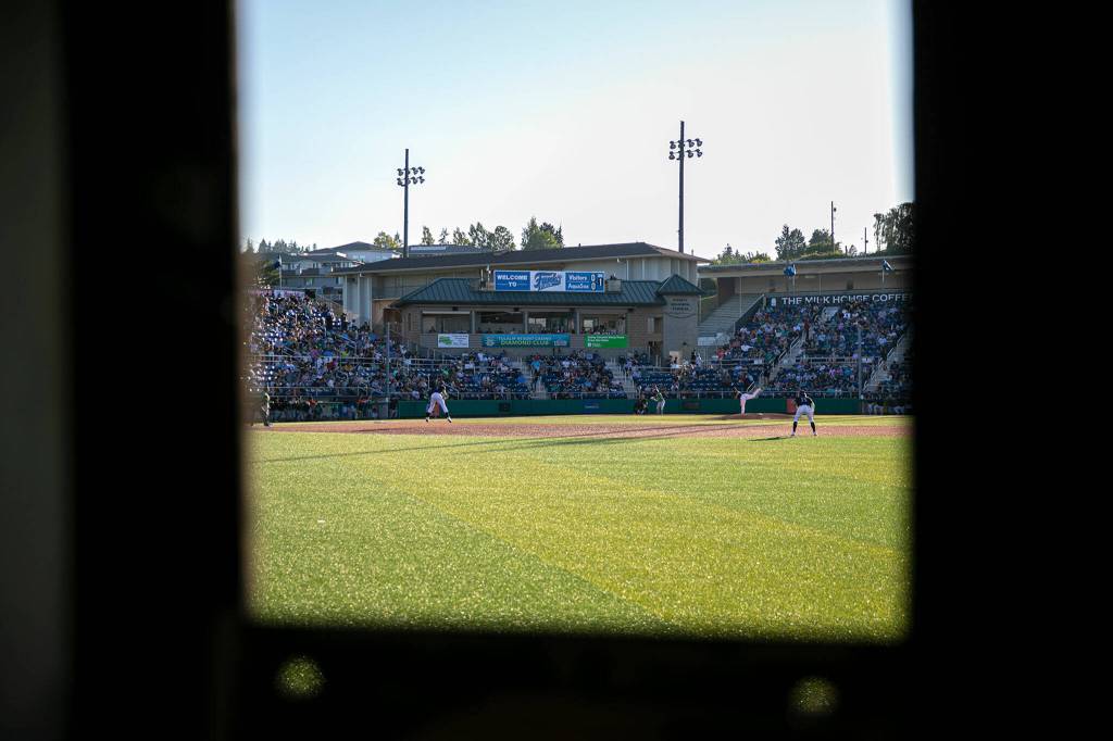 The AquaSox and Emeralds are seen playing from the manual scoreboard on Saturday, July 23, 2022, at Funko Field in Everett, Washington. (Ryan Berry / The Herald)