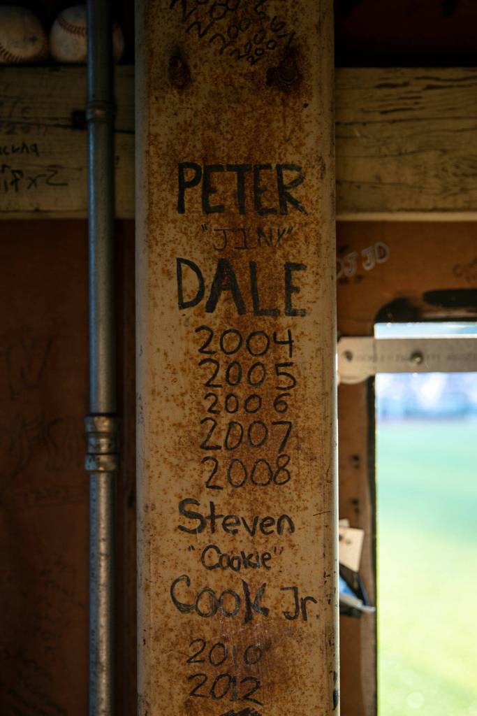 Some of the dozens of names scrawled within the manual scoreboard are seen on a metal post Saturday, July 23, 2022, at Funko Field in Everett, Washington. (Ryan Berry / The Herald)