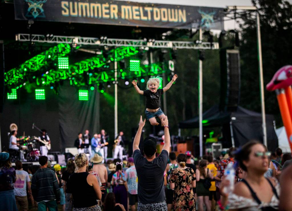 Tala Davey-Wraight, 3, is thrown in the air by her dad Oscar Davey-Wraight, one of the Summer Meltdown headliners also known as Opiuo, during Cory Wongs set on Thursday, in Snohomish. (Olivia Vanni / The Herald)