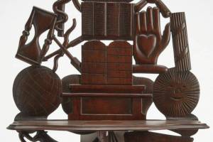 Photo Caption: This carved shelf brought $2,500 at New Haven Auctions. Decorations and symbols associated with the Odd Fellows add to its appeal.