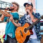 Preston Brust, left, and Chris Lucas of LOCASH perform during CMA Fest 2022 on Thursday, June 8, 2022, at the Chevy Riverfront Stage in Nashville, Tenn. (Photo by Amy Harris/Invision/AP)