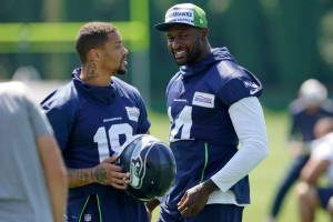 Seattle Seahawks wide receiver DK Metcalf, right, talks with wide receiver Freddie Swain during NFL football training camp Thursday, July 28, 2022, in Renton, Wash. (AP Photo/Ted S. Warren)