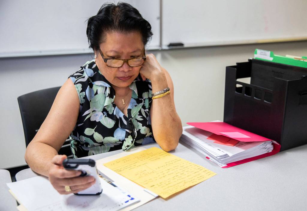 Executive director of Refugee & Immigrant Services Northwest Van Kuno makes a phone call to a landlord to inquire about housing for Ukrainian refugees on July 20, in Everett. (Olivia Vanni / The Herald)