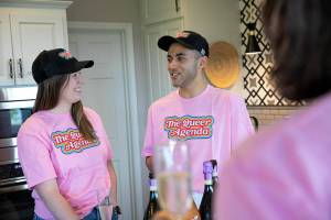 Lily Stephens Barnsby and Drake Wilson, co-executive producers of “The Queer Agenda: A Great American Road Trip,” take turns proposing a champaign toast with their families and supporters the night before heading out to travel the country and create their documentary, on Wednesday, Aug. 3, 2022, at a home in Everett, Washington. (Ryan Berry / The Herald)