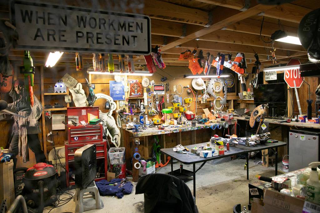 The HaazLab, Josh Haazard’s personal workshop, is covered ceiling to floor in stickers, props and work materials on Thursday, Aug. 4, 2022, at Haazard’s home in Monroe, Washington. (Ryan Berry / The Herald)