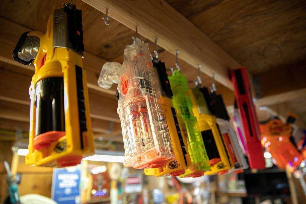 Nerf guns hang from the ceiling in Josh Haazards workshop. (Ryan Berry / The Herald)