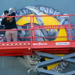 Spawk works on a new downtown from the top of a shaky scissor lift on Friday, along Rucker Ave. in Everett. (Ryan Berry / The Herald)