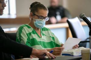 Desiree Gott looks over documents before her sentencing Thursday, Aug. 4, 2022, at Snohomish County Superior Court in Everett, Washington. (Ryan Berry / The Herald)