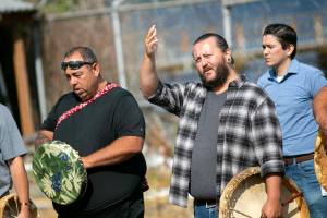 Andrew Gobin of the Tulalip Tribes greets members of NOAA before the playing of a welcome song during a ceremony Monday, Aug. 1, 2022, at the decommissioned NOAA building on the waterfront in Mukilteo, Washington. (Ryan Berry / The Herald)