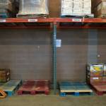 Pallets typically filled with foodstuffs are completely empty as the Everett Food Bank experiences never-before-seen shortages on Friday, in Everett. These storage areas are often two pallets deep, but many are now completely empty. (Ryan Berry / The Herald)