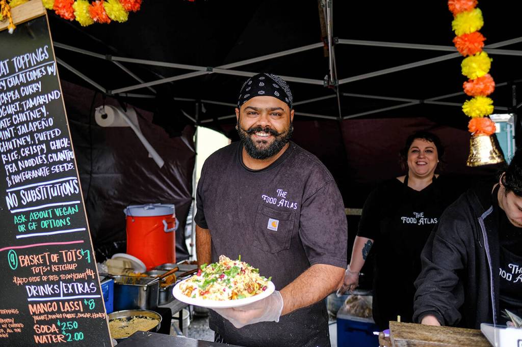 Yuvi Joshi of The Food Atlas shows off samosa chaat, an Indian street flavor bomb: Samosa, a fried veggie-stuffed pastry is topped with chana masala (a North Indian chickpea dish). The dish is doused with chickpea curry yogurt, tamarind date chutney, mint jalapeno chutney and then showered with puffed rice, chickpea noodles, cilantro and pomegranate. (Taylor Goebel / The Herald)
Yuvi Joshi of The Food Atlas shows off samosa chaat, an Indian street flavor bomb: Samosa, a fried veggie-stuffed pastry is topped with chana masala (a North Indian chickpea dish). The dish is doused with chickpea curry yogurt, tamarind date chutney, mint jalapeño chutney and then showered with puffed rice, chickpea noodles, cilantro and pomegranate. (Taylor Goebel / The Herald)