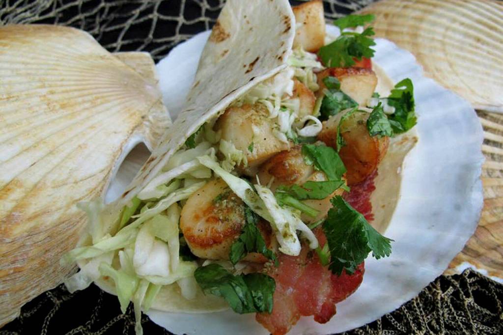 The Scallorito from Alaska Weathervane Scallops is their take on a taco: They stuff flour tortillas with 1/4 pound of pan-seared scallops  caught right off their boat  then top em with crispy bacon, pesto coleslaw, cilantro and onions. (Alaska Weathervane Scallops / Everett Food Truck Festival)