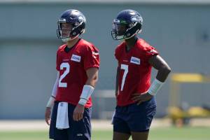 Seattle Seahawks quarterback Drew Lock, left, stands with quarterback Geno Smith, right, during NFL football practice Thursday, July 28, 2022, in Renton, Wash. (AP Photo/Ted S. Warren)