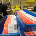 Vote-by-mail ballots are shown in sorting trays, Aug. 5, 2020, at the King County Elections headquarters in Renton. (AP Photo / Ted S. Warren)