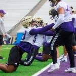 Washington edge Zion Tupuola-Fetui (front left) and teammates take part in the teams fist preseason practice on Thursday at Husky Stadium in Seattle. (Erika Schultz/The Seattle Times via AP)