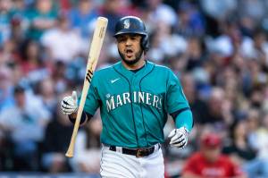 Seattle Mariners' Eugenio Suárez flips his bat after earning a walk from Los Angeles Angels pitcher Patrick Sandoval during the first inning of a baseball game, Friday, Aug. 5, 2022, in Seattle. (AP Photo/Stephen Brashear)