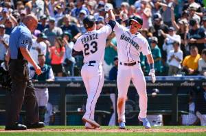 Seattle Mariners' Ty France (23) celebrates at the plate with Jarred Kelenic after hitting a two-run home run during the third inning of a baseball game against the Los Angeles Angels, Saturday, Aug. 6, 2022, in Seattle. (AP Photo/Caean Couto)