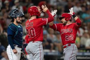 Los Angeles Angels' David Fletcher, right, is congratulated by Jared Walsh after hitting a two-run home run off Seattle Mariners starting pitcher Chris Flexen during the sixth inning in the second game of a baseball doubleheader, Saturday, Aug. 6, 2022, in Seattle. Walsh scored on the homer. (AP Photo/Stephen Brashear)