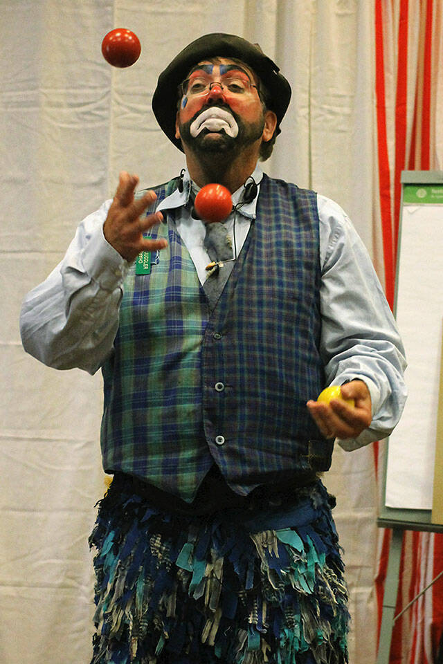 Bruce Johnson juggles balls while dressed in his clown attire. (Merilyn Barrett)