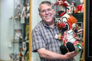 Bruce Johnson has an exhibit on the history of clowns at the Lynnwood Library in Lynnwood, Washington on August 11, 2022. (Kevin Clark / The Herald)