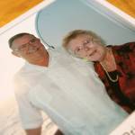 An old photo of Rev. Barbara Rasberry and her late husband Don on a cruise in the Caribbean sits on the kitchen table at her home, the Purple Wedding Chapel. (Ryan Berry / The Herald)