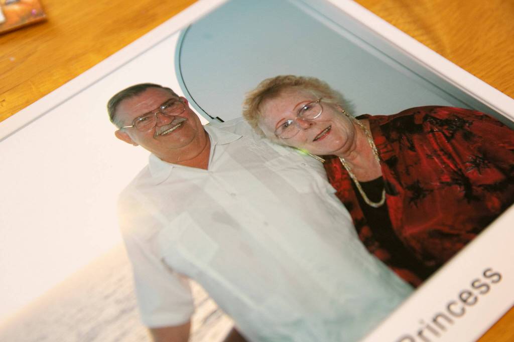An old photo of Rev. Barbara Rasberry and her late husband Don on a cruise in the Caribbean sits on the kitchen table at her home, the Purple Wedding Chapel. (Ryan Berry / The Herald)