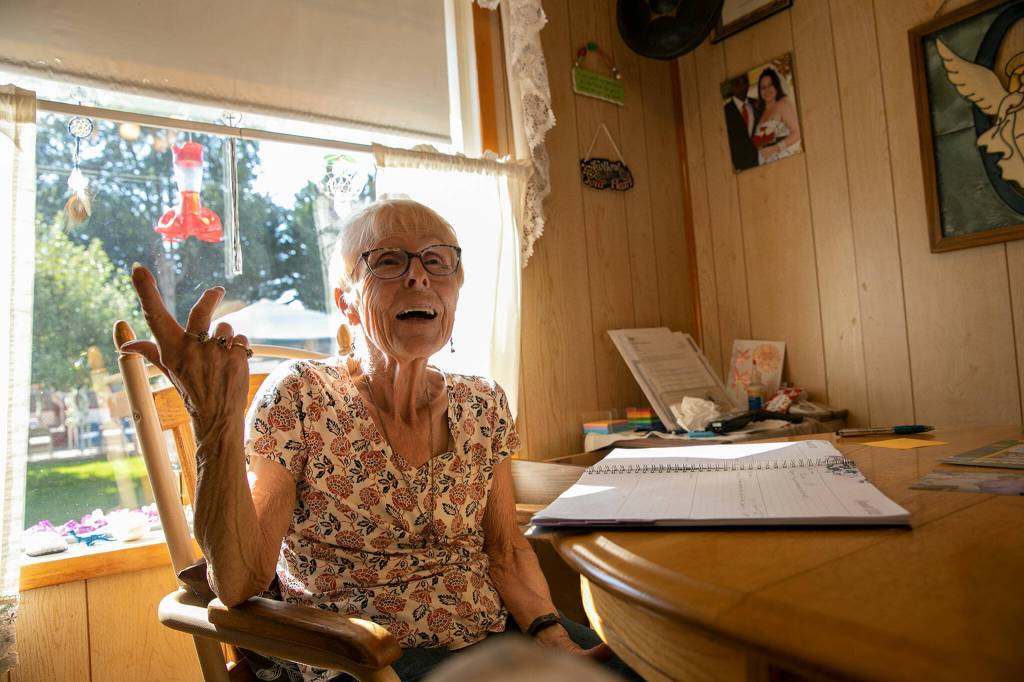 Rev. Barbara Rasberry sits in her kitchen and looks over her upcoming weddings at her home, the Purple Wedding Chapel. (Ryan Berry / The Herald)
