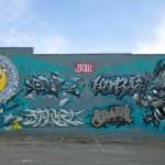 A samurai and dragon mural created during the “Going All City NW” event is seen the evening of Monday, Aug. 8, 2022, before being painted over on Tuesday along Rucker Ave. in Everett, Washington. (Ryan Berry / The Herald)