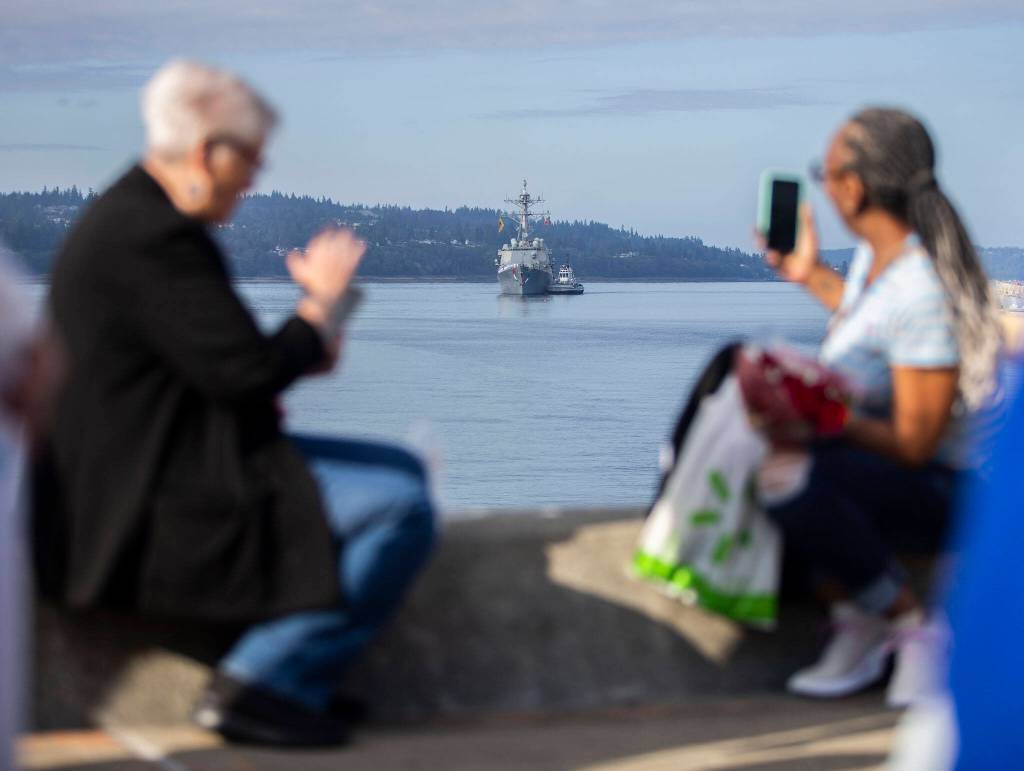Friends and family take photos and videos as the U.S.S. Gridley comes in at Naval Station Everett on Thursday, in Everett. (Olivia Vanni / The Herald)
