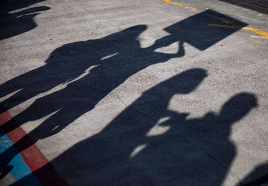 People lineup up along the dock at Naval Station Everett on Thursday, in Everett. (Olivia Vanni / The Herald)