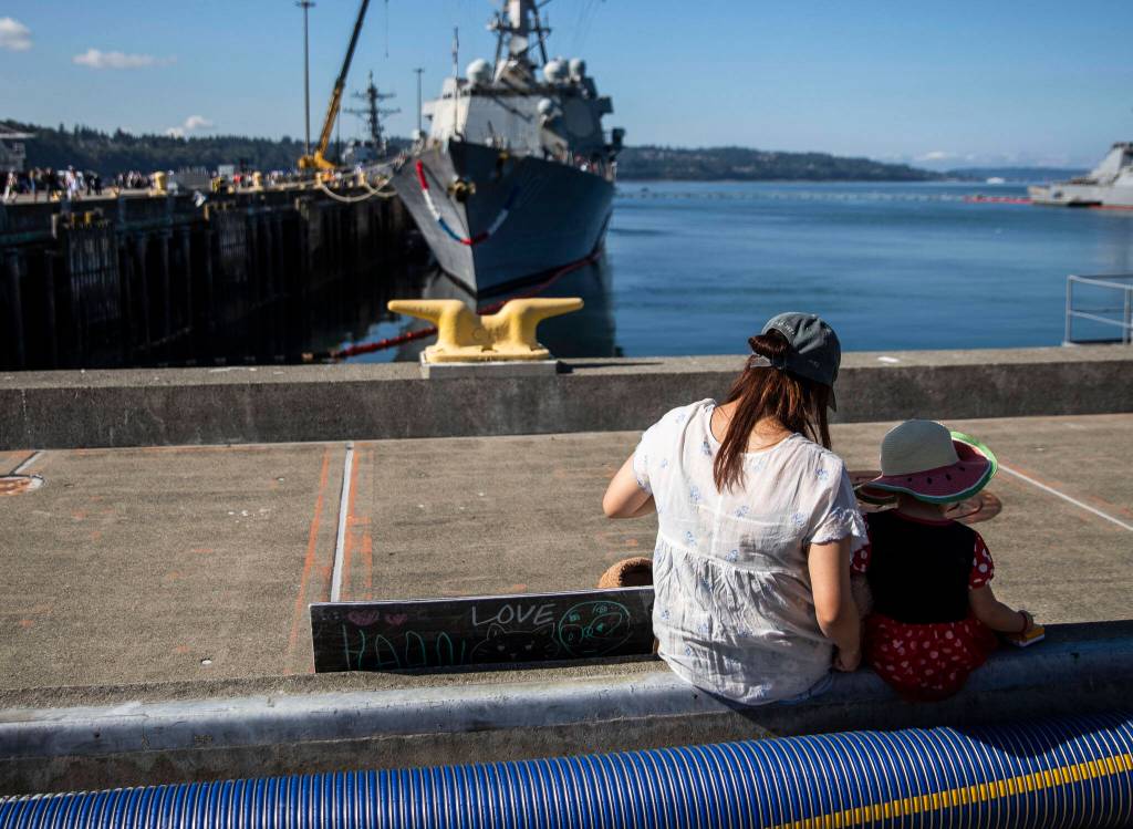 Ayako Johnson and her daughter Hana, 4, wait for the next ship to come in at Naval Station Everett on Thursday, in Everett. (Olivia Vanni / The Herald)