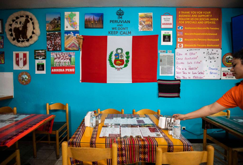A wall covered in Peruvian photos, flags and other items at Rinconcito Peruano Restaurant on Saturday, in Lynnwood. (Olivia Vanni / The Herald)