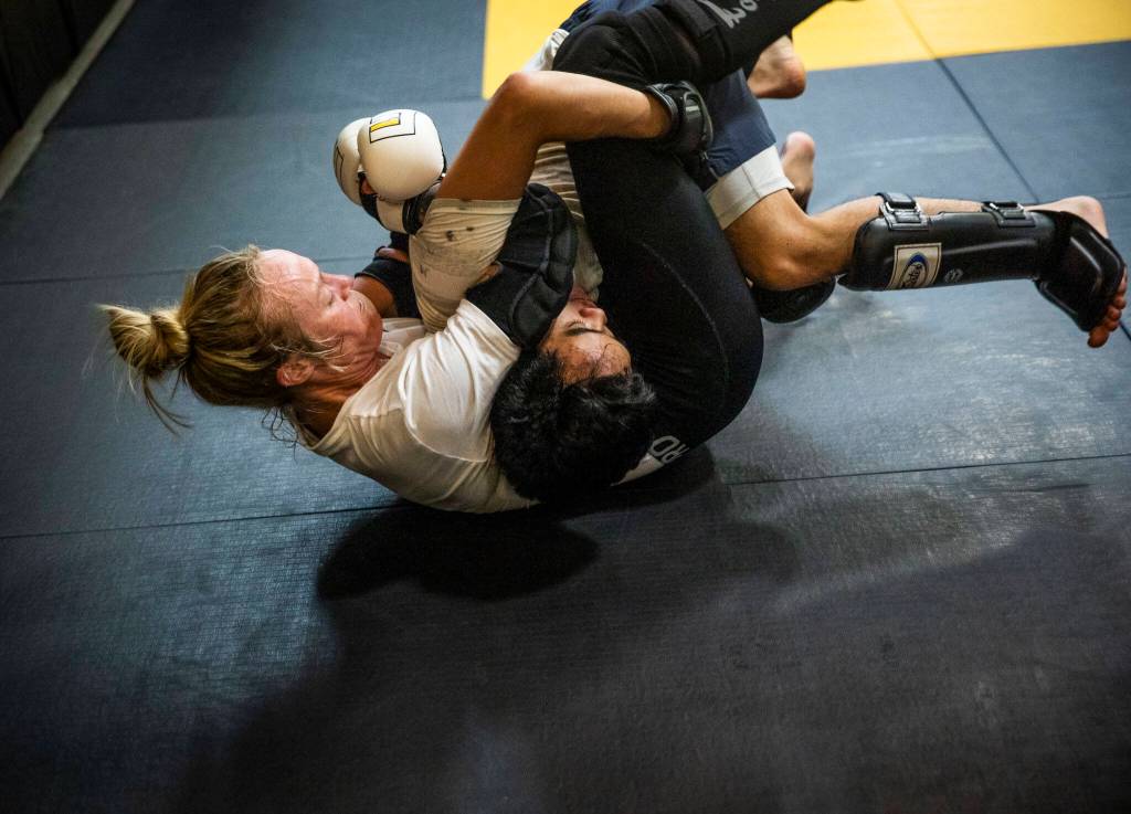 Miranda Granger grapples with Eddy Kouthong during one of her fight camp training sessions at Charlies Combat Club on Thursday, July 21, 2022, in Everett, Washington. (Olivia Vanni / The Herald)