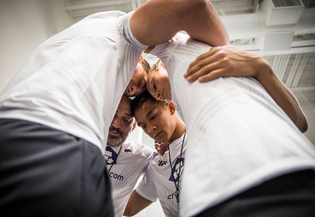 Miranda Granger and her corner  husband Kaden Barish, coach Charlie Pearson and training partner Bilal Hasan  say a prayer before heading out to the Octagon for her fight at the UFC Apex on Saturday, Aug. 6, 2022, in Las Vegas. (Olivia Vanni / The Herald)